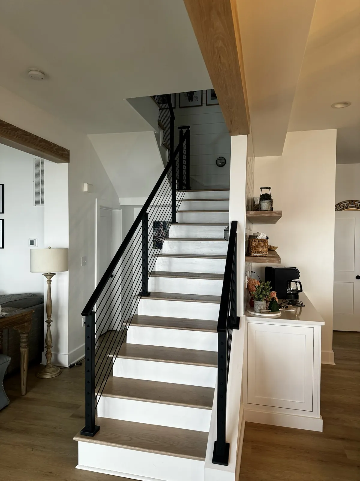 Renovated staircase with white risers and black metal railing
